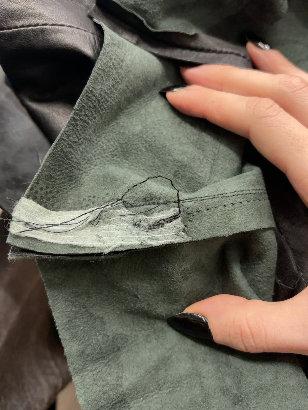 Black leather mini skirt seam detail
