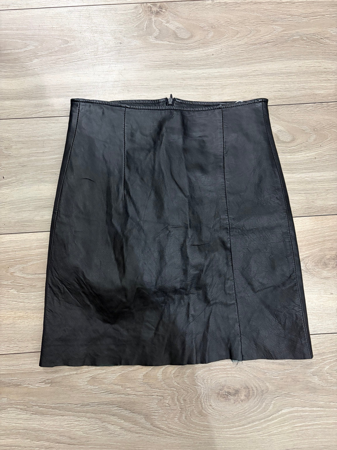 Black leather mini skirt front on white