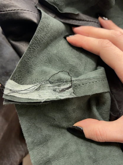 Black leather mini skirt seam detail